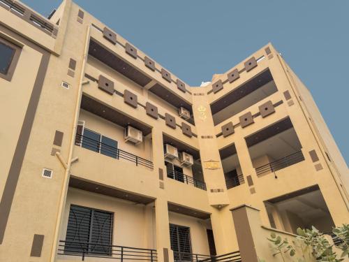 a building with balconies on the side of it at Hotel Ananta Vista in Jāwad