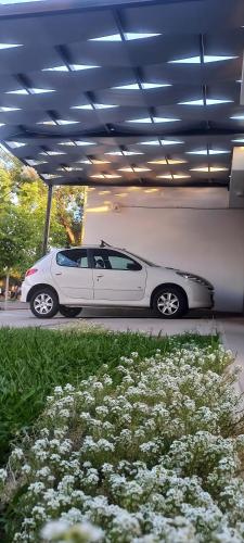a white car parked under a parking garage at Sueños Del Pilar II # Mendoza # Casa Depto en G Cruz # Estacionamiento # Bodegas in Mendoza