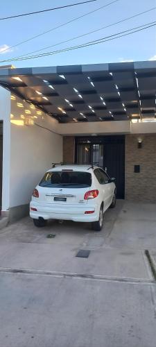 a white car parked in a parking lot at Sueños Del Pilar II # Mendoza # Casa Depto en G Cruz # Estacionamiento # Bodegas in Mendoza