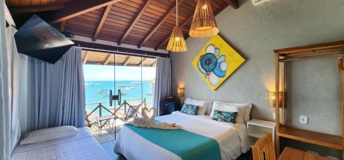 a bedroom with two beds and a view of the ocean at Bamboo Búzios Hostel in Búzios