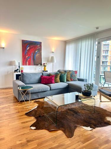 a living room with a couch and a table at Luxury apartment in Canary Wharf in London