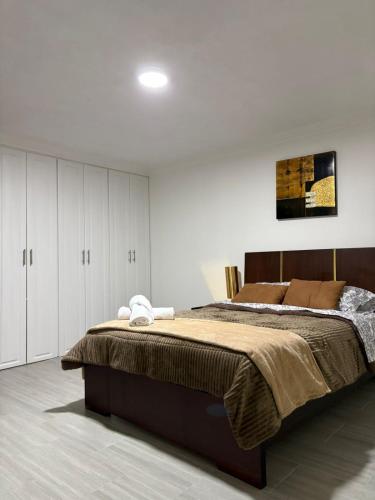 ロハにあるCasa Moderna en Loja - ideal para familiasのベッドルーム(大型ベッド1台、白いキャビネット付)