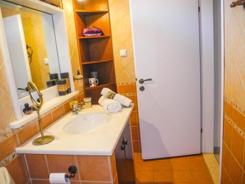 a bathroom with a sink and a mirror at Lea's Ηοme in Kourouta