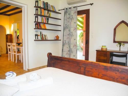 a bedroom with a bed and a mirror and a desk at Lea's Ηοme in Kourouta