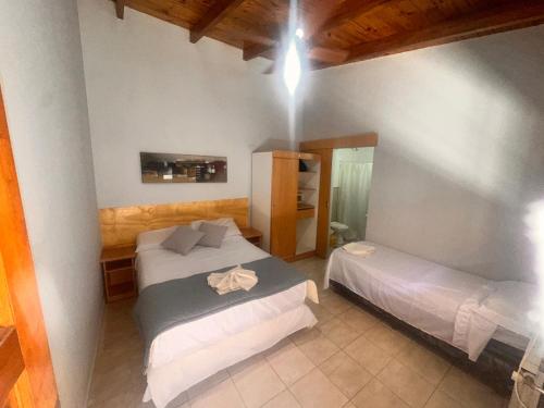 een slaapkamer met twee bedden in een kamer bij Hotel en villa carlos paz centrico con desayuno y pileta Nuevo Enzo in Villa Carlos Paz