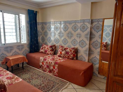 a room with a bed and a couch and a window at Dream House Sidi Rahal Beach in Sidi Rahal