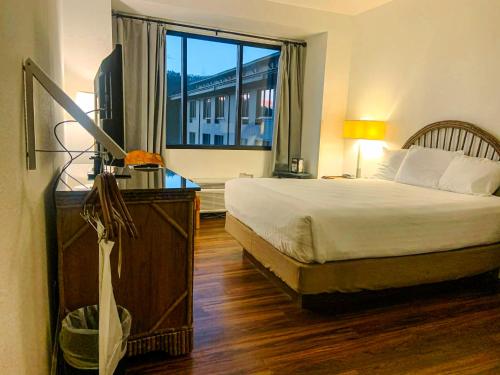 a bedroom with a bed and a large window at Unicoi State Park & Lodge in Helen