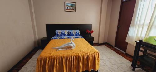 Una cama o camas en una habitación de Hostal Bless Tacna