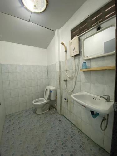 a bathroom with a toilet and a sink at Pineapple Resort Sam roi yot in Sathani Sam Roi Yot
