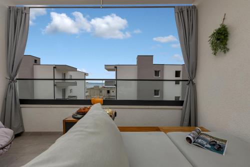 En eller flere senge i et værelse på Apartman Aria De Lux