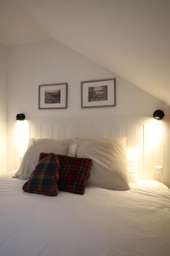 a bedroom with a white bed with two pillows at Les Cimes - Le Tholy in Le Tholy