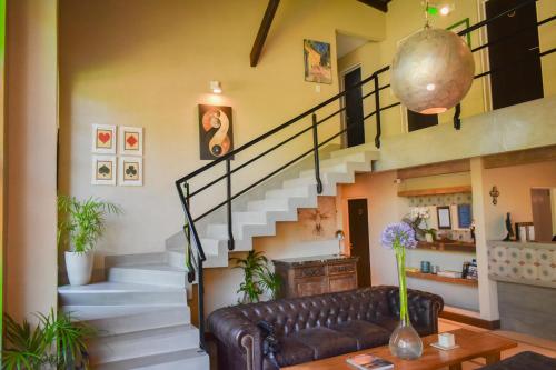 a living room with a couch and stairs at Hotel San Germán de Muñiz in Muñiz