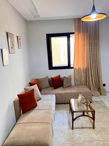 a living room with a couch and a table at Palmier d'or in Tunis