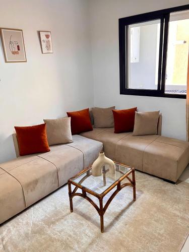 a living room with two couches and a coffee table at Palmier d'or in Tunis