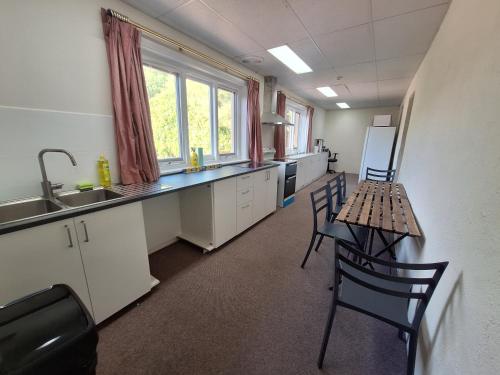 a room with a kitchen with a table and chairs at Adelaide Free Souls in Adelaide