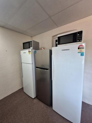 two refrigerators are sitting next to each other in a room at Adelaide Free Souls in Adelaide