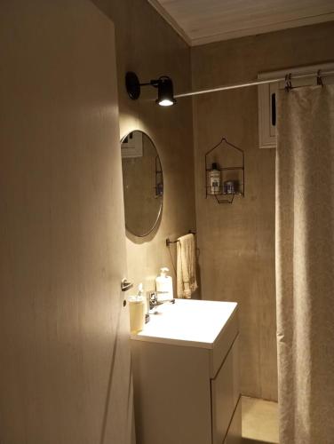 a bathroom with a sink and a mirror and a shower at Casa de montaña in Cortaderas