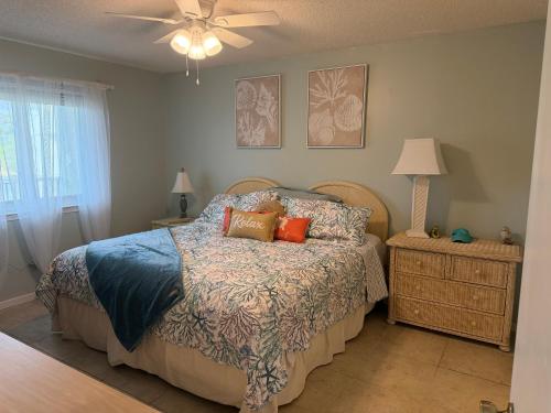 a bedroom with a bed and a ceiling fan at Latitude 302 in Orange Beach