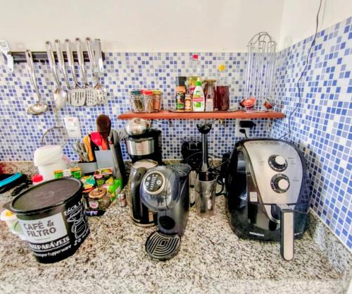 a kitchen counter with pots and pans and a toaster at Casa de Adobe in Lençóis