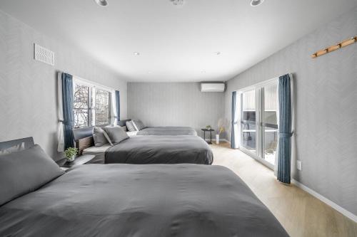 En eller flere senge i et værelse på Villas Park Kamifurano