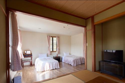 Postel nebo postele na pokoji v ubytování カナリアンホテル