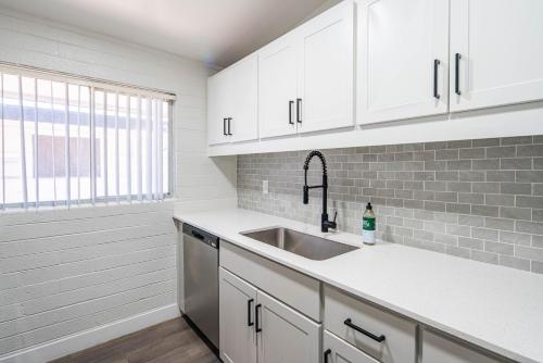 a kitchen with white cabinets and a sink at Spacious 2 Bedroom, 2 Bath, Pool, Free Parking, Gym in Scottsdale
