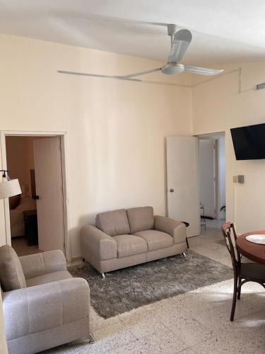a living room with a couch and a table at Apartment in Merida in Mérida