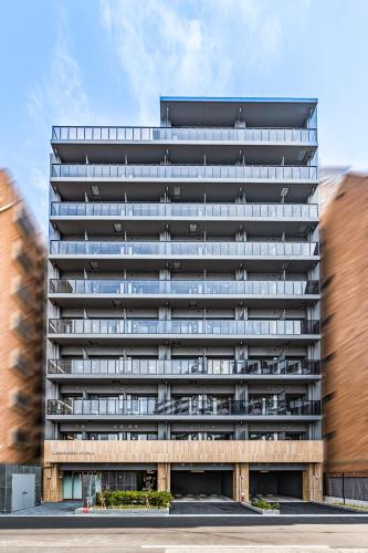 an external view of a tall building with balconies at Apartment Hotel 11 Nambaminami 5 in Osaka