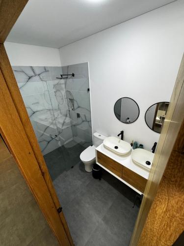 a bathroom with a sink and a toilet and a mirror at Luxury estate in San Jerónimo with infinity pool in San Jerónimo