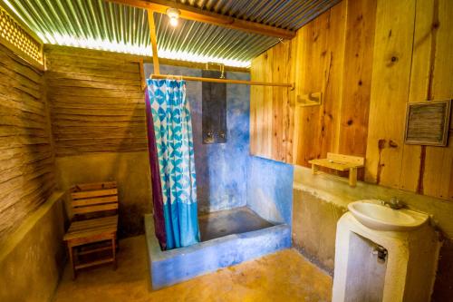 a bathroom with a toilet and a bath tub at Eco-Hotel Mayachik in San Juan La Laguna
