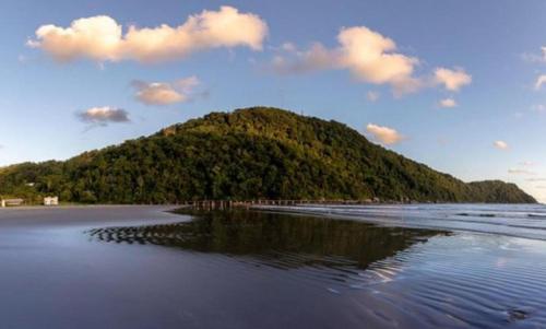 a small island in the middle of a beach at Badaró's Beach in Praia Grande