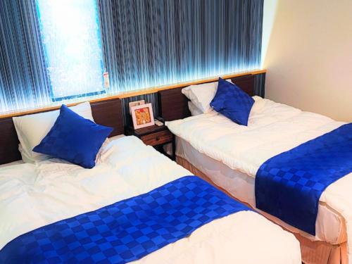 En eller flere senge i et værelse på YUTO Ishigakijima