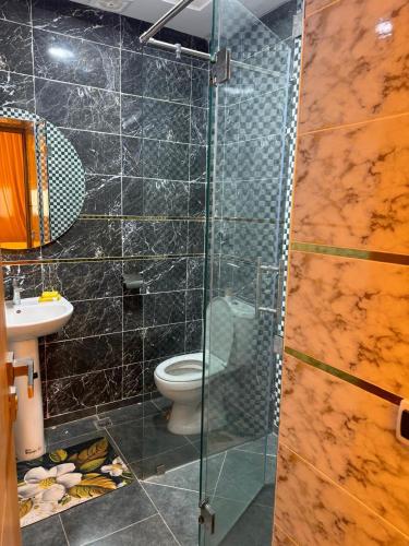 a bathroom with a glass shower with a toilet at Dar aya comfort in Oulad Embarek