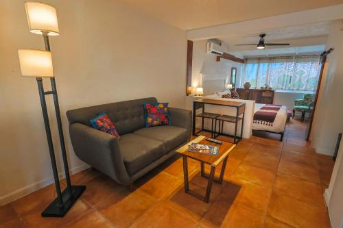 a living room with a couch and a table at Stylish Studio in the Heart of Zona Romántica in Puerto Vallarta