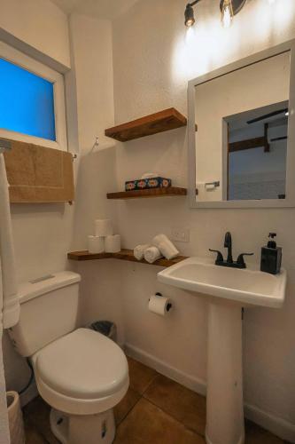 a bathroom with a toilet and a sink and a mirror at Stylish Studio in the Heart of Zona Romántica in Puerto Vallarta