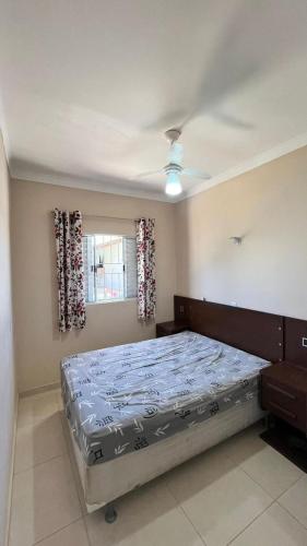 a bedroom with a large bed in a room at Recanto Maria de Souza in Caçapava