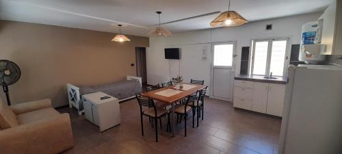 ein Wohnzimmer mit Tisch und Küche in der Unterkunft Complejo Solares in Villa Carlos Paz