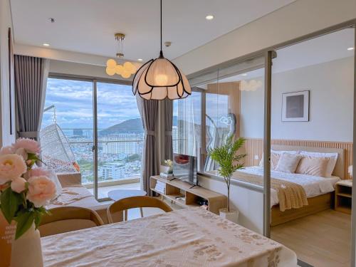 ViVi's Home - The Sóng Apartment Vũng Tàu في فنغ تاو: غرفة نوم بها سرير ونافذة كبيرة
