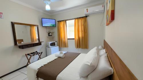 Ένα ή περισσότερα κρεβάτια σε δωμάτιο στο Água Marinha de Bombas - Bombinhas