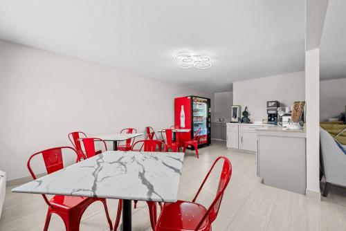 a dining room with a table and red chairs at Econo Lodge Biloxi Beach in Biloxi