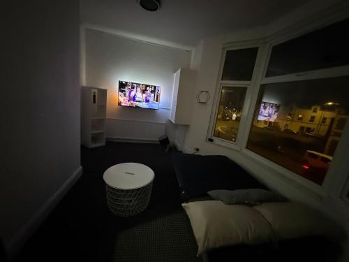 a bedroom with a bed and a window with a tv at Principality Stadium & City Centre on the Doorstep in Cardiff