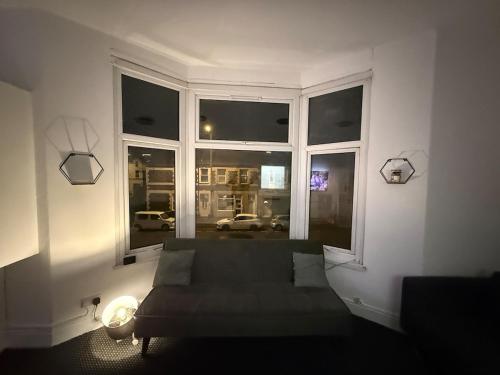 a living room with a couch in front of a window at Principality Stadium & City Centre on the Doorstep in Cardiff