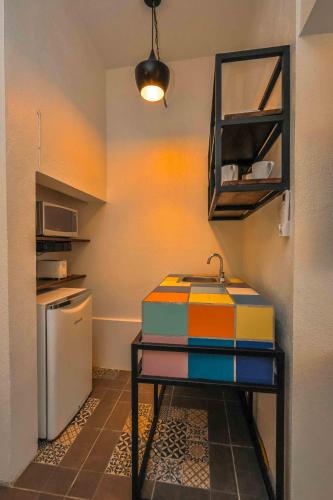 a kitchen with a table and a refrigerator at Cozy & Fully Equipped Studio in Zona Romantica in Puerto Vallarta