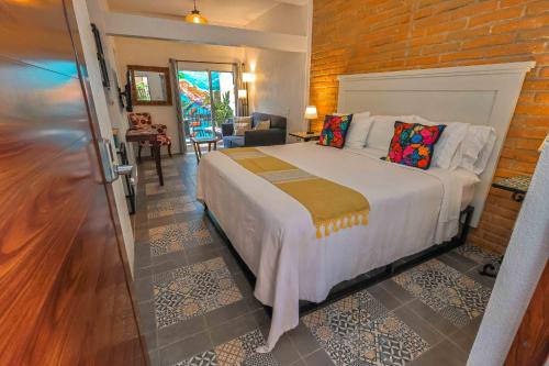 a bedroom with a bed and a brick wall at Cozy & Fully Equipped Studio in Zona Romantica in Puerto Vallarta