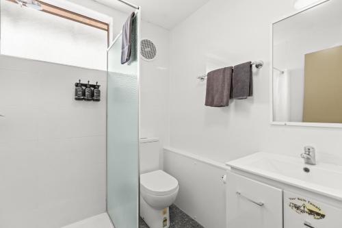 Broome Time Resort في بروم: حمام أبيض مع مرحاض ومغسلة