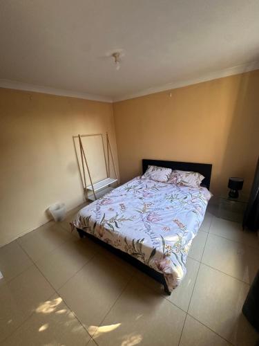 a bedroom with a bed in the corner of a room at Budget Queen Room - 492 in Wentworthville