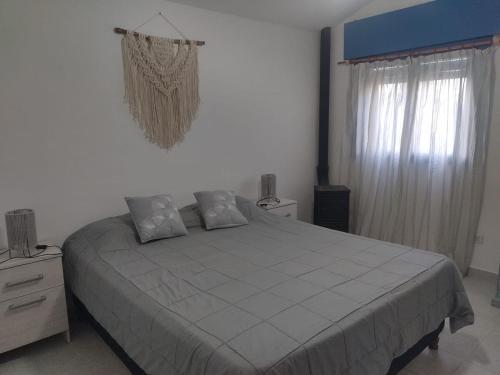a bedroom with a large bed and a window at La Calma in Los Reartes