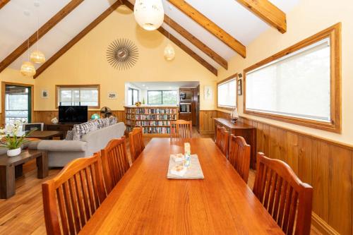 a dining room with a wooden table and chairs at Cascade View - 4 Bedroom House in Cascade
