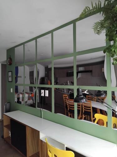 a dining room with a large glass wall at CENTRAL APARTMENT IN THE HEART OF MEXICO CITY in Mexico City
