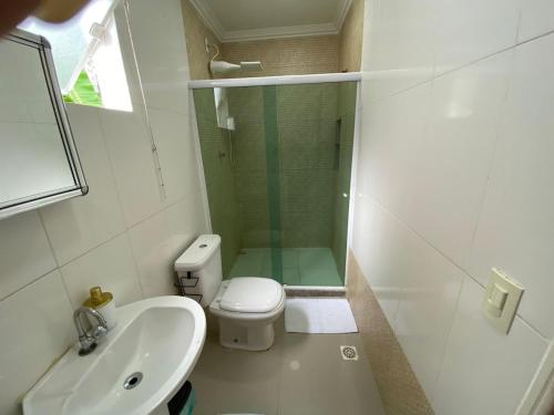 a bathroom with a shower and a toilet and a sink at Casa independente em tuncuns in Búzios